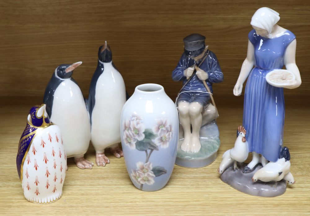 A Bing & Grondahl porcelain figure of a girl, a Royal Copenhagen figures, a pair of penguins, a vase and Royal Crown Derby penguin pape